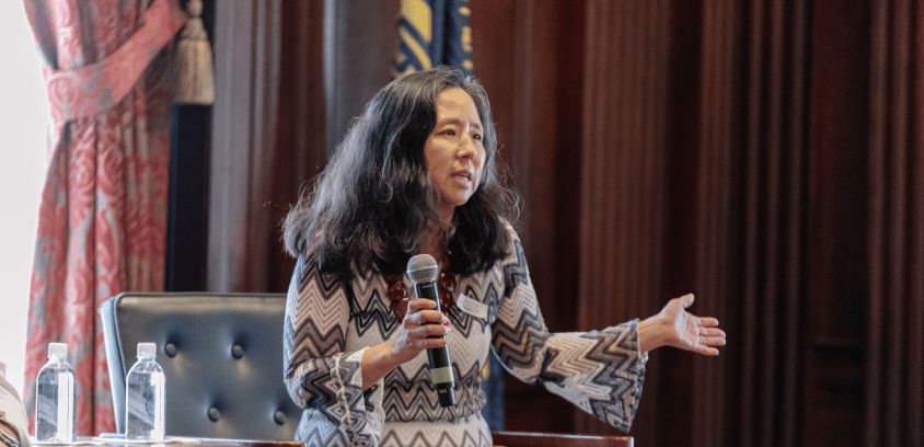 Sunny Cutler, senior consultant at Lincoln Financial, speaks at an event in Philadelphia, engaging the audience with purposeful gestures and a microphone.