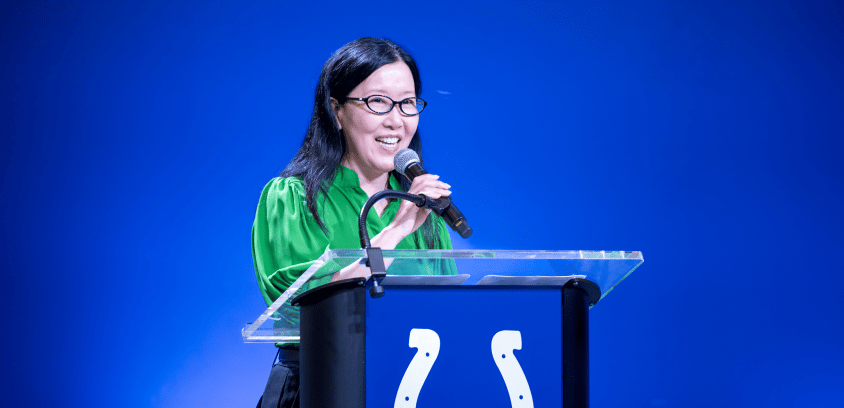 Jasmine Park, vice president of people, culture, and inclusion at the Indianapolis Colts, delivers strategic opening remarks at the podium.