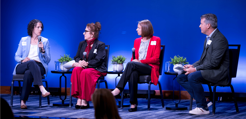 A panel of strategic leaders takes the stage at Gridiron Hall, Indiana Farm Bureau Football Center, featuring voices from The MJ Companies, Indiana University, and Marathon Health.