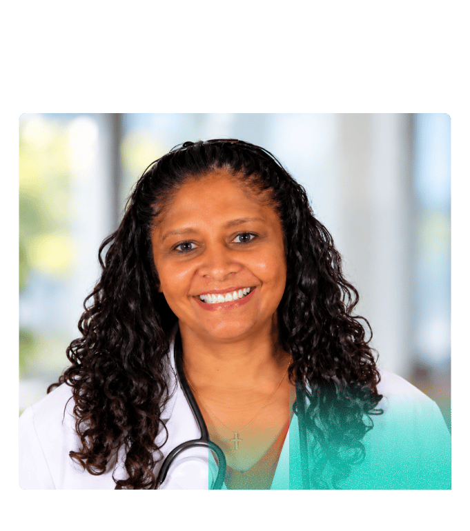 Dr. Aasha Trowbridge, medical director of virtual care at Marathon Health, smiling in a white lab coat with a stethoscope.