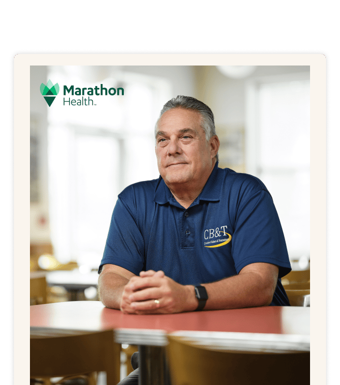 A professional in a blue polo shirt explores advanced primary care solutions for their Taft-Hartley health plan.