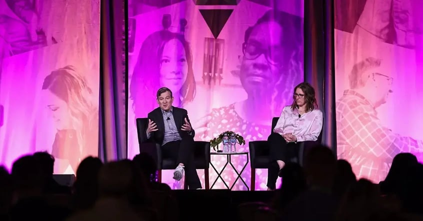 Dan Harris giving a talk on stage at ENGAGE 2025 conference.