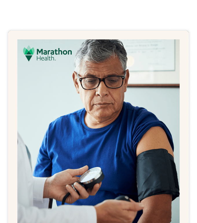 Doctor measuring a patient's blood pressure with a manual blood pressure cuff.