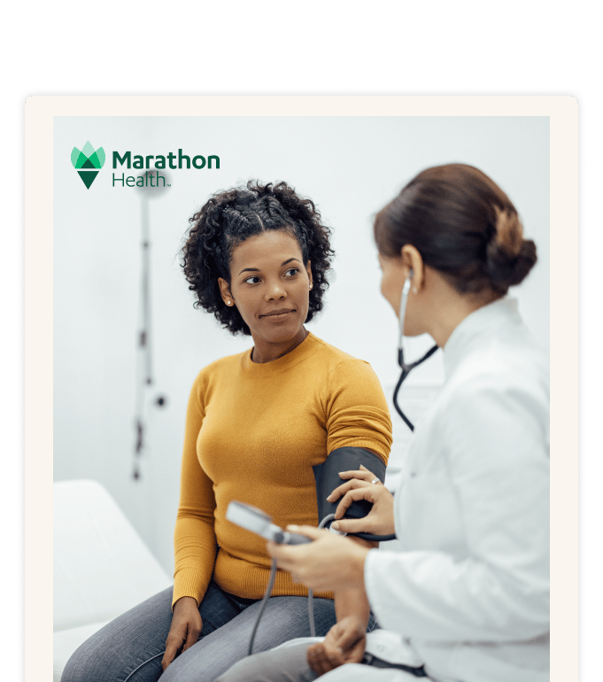 Marathon Health physician checking a patient's blood pressure during an advanced primary care visit.