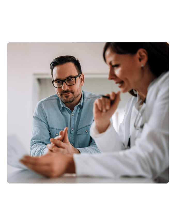 Healthcare provider reviewing her male patient's health screening results. 