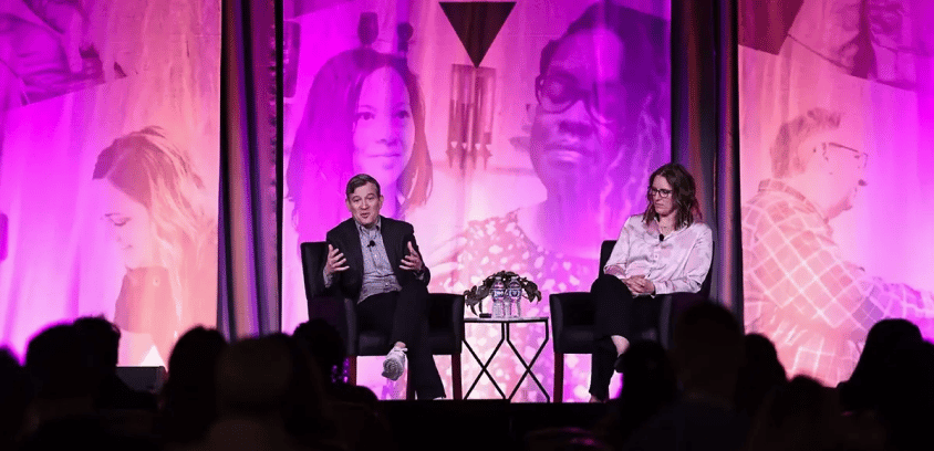 Dan Harris giving a talk on stage at ENGAGE 2025 conference.