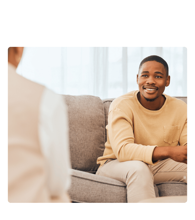 Person suffering from PTSD in a conversation with a mental health practitioner.