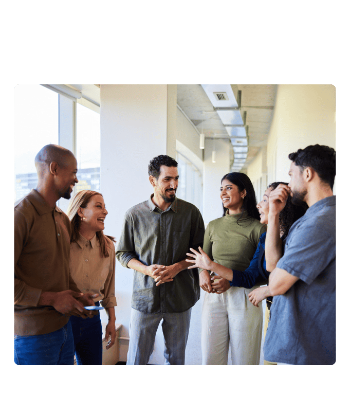 Group of coworkers gathered in an office hallway during a corporate wellness program.
