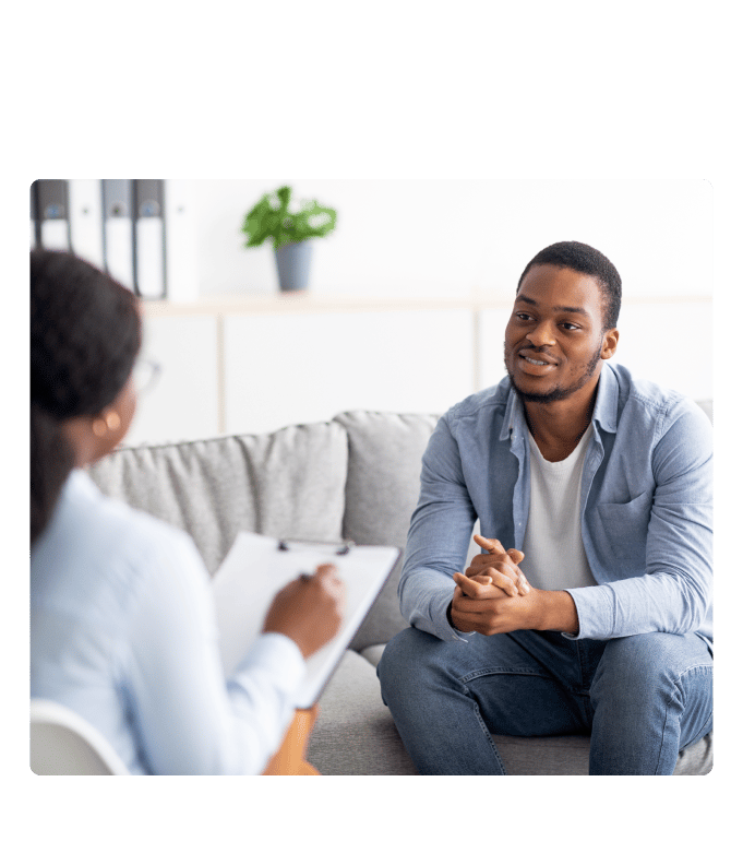 Mental health practitioner in a conversation with a patient in an office.