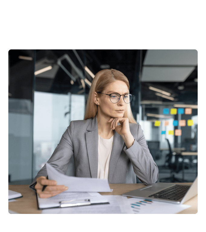 Person in a blazer reviewing average employer health insurance cost documents.