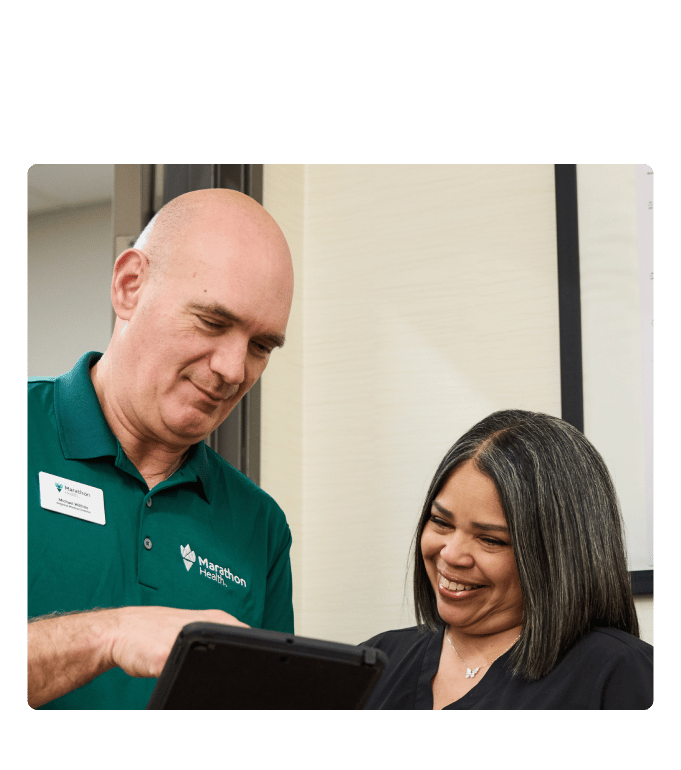 Marathon Health provider reviewing results with a patient on a tablet.