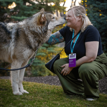 ENGAGE 2026 attendee playing with a dog.