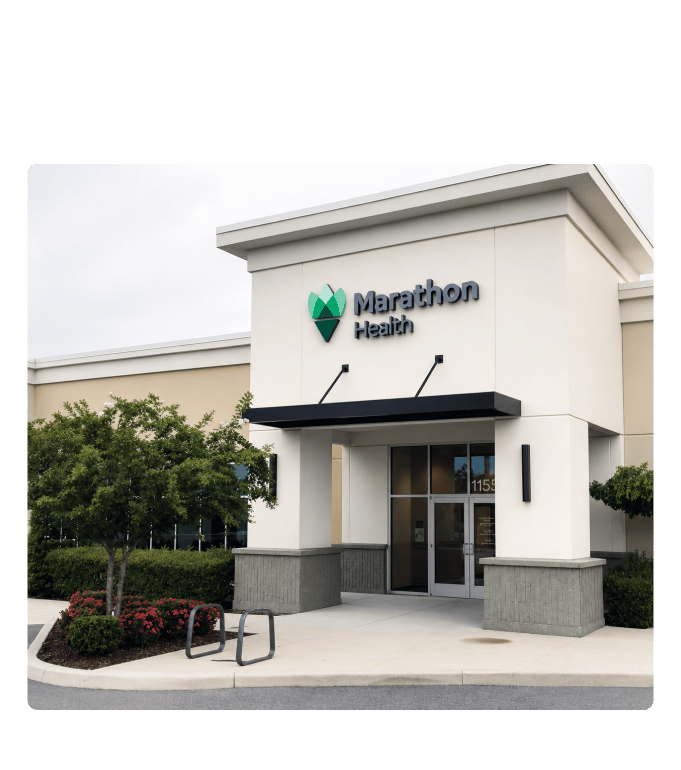Exterior of a Marathon Health employee health center with signage above the entrance and landscaped surroundings