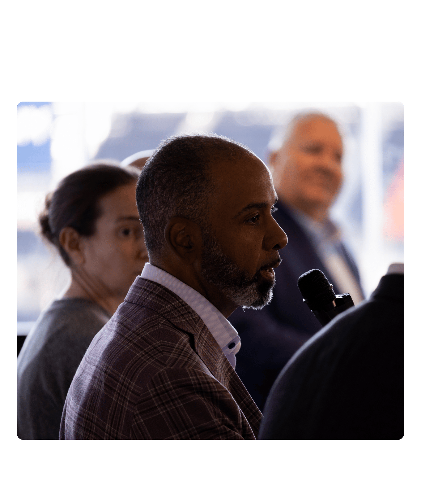 Marc Watkins speaking into a microphone at the Ohio workforce health roundtable.