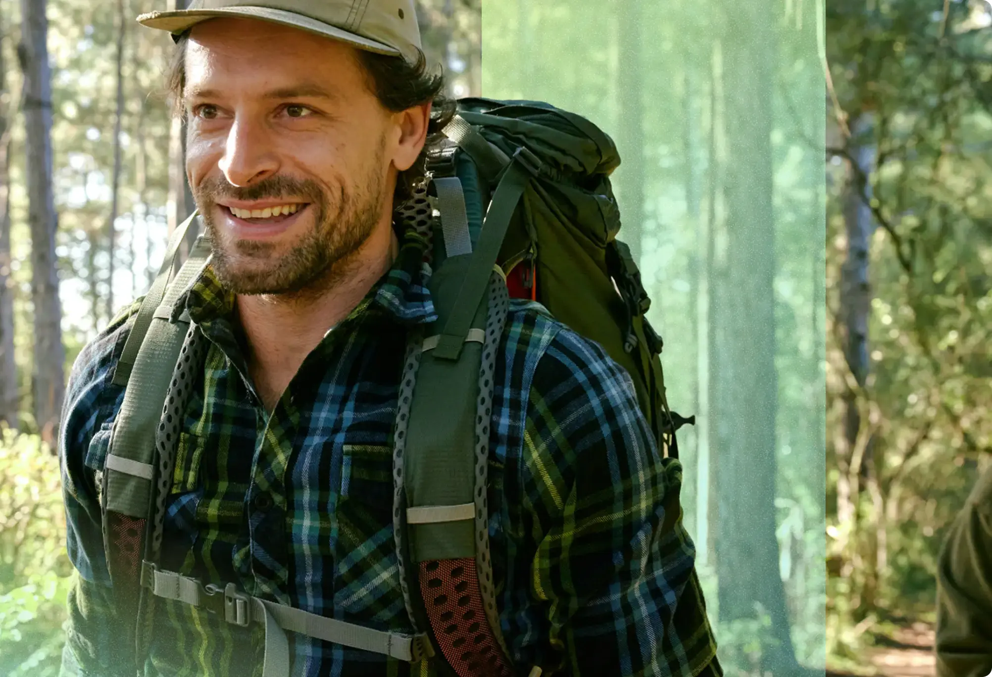 Smiling hiker walking through the woods in Indiana.