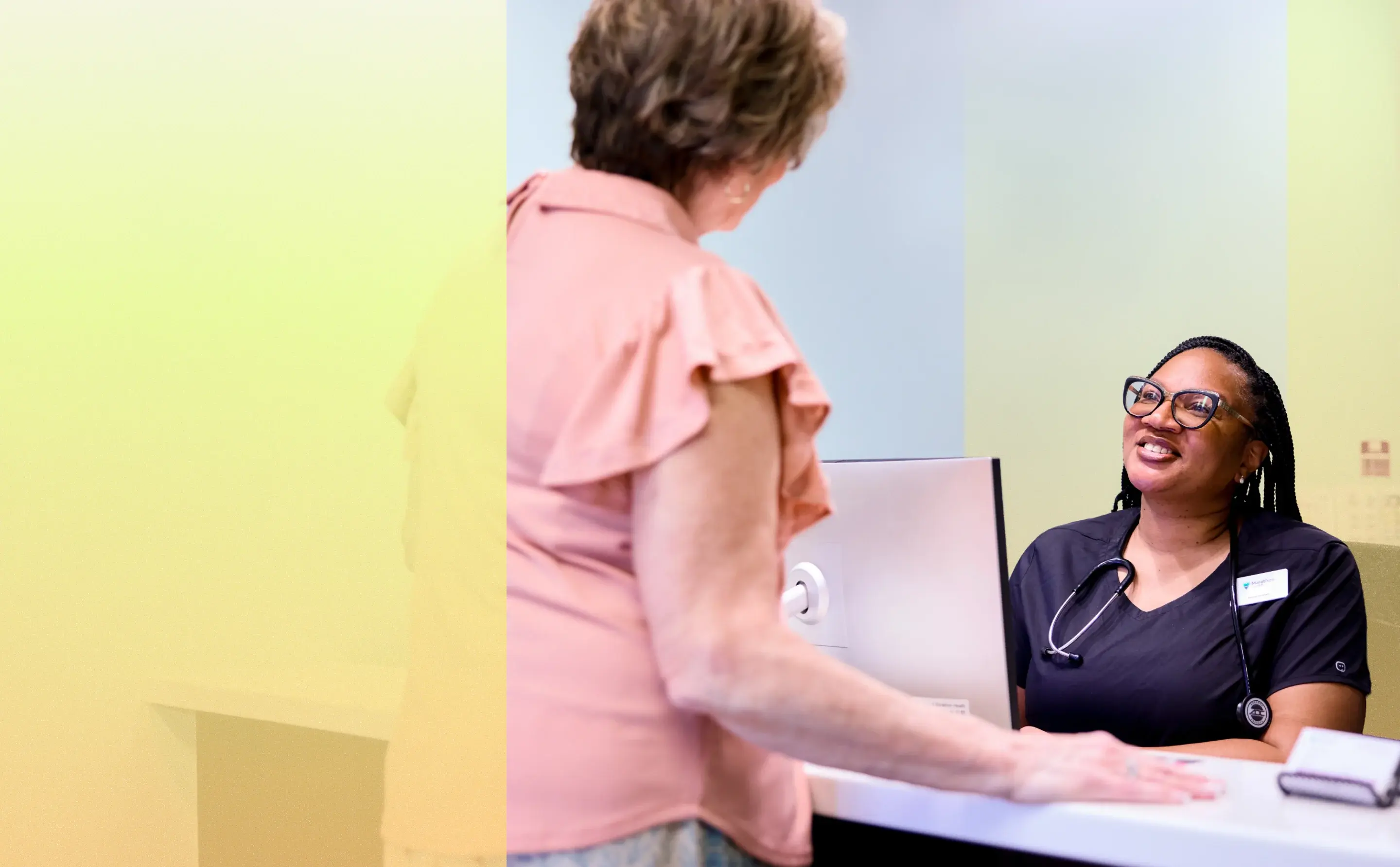 Marathon Health network health center receptionist greeting a patient.
