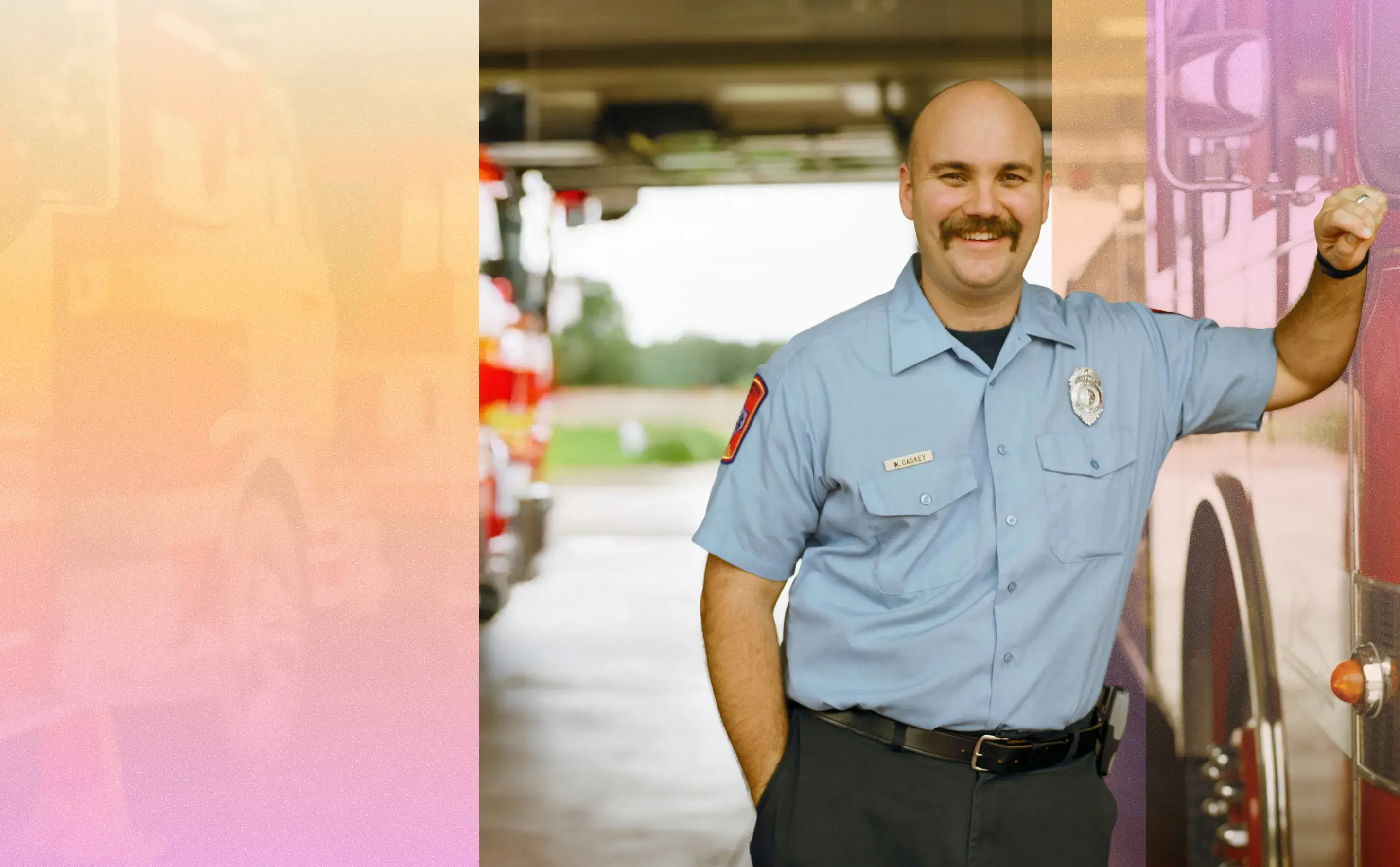 Fire department employee standing up against a fire truck. 