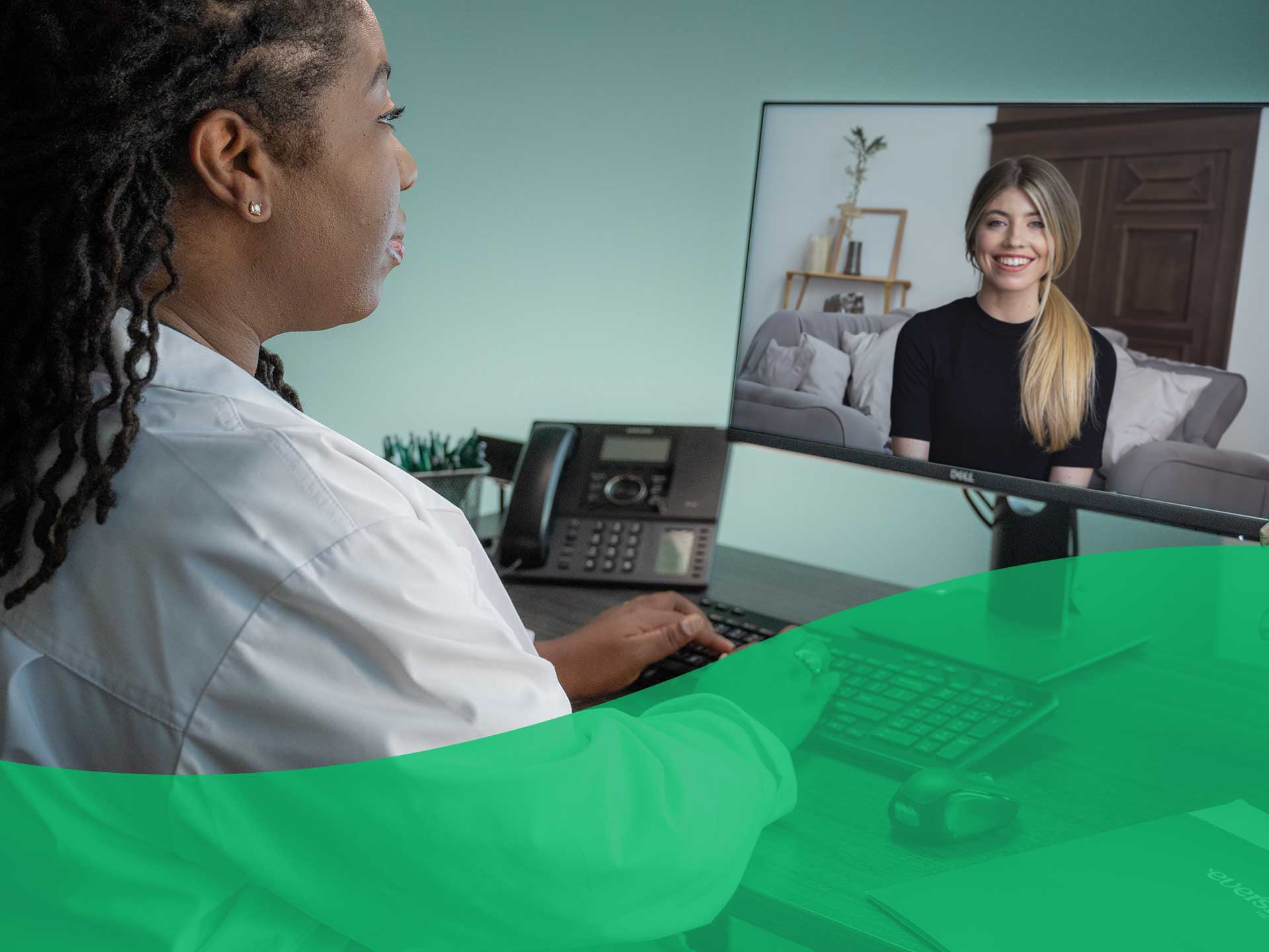 patient smiling in a computer screen while on a virtual call with doctor