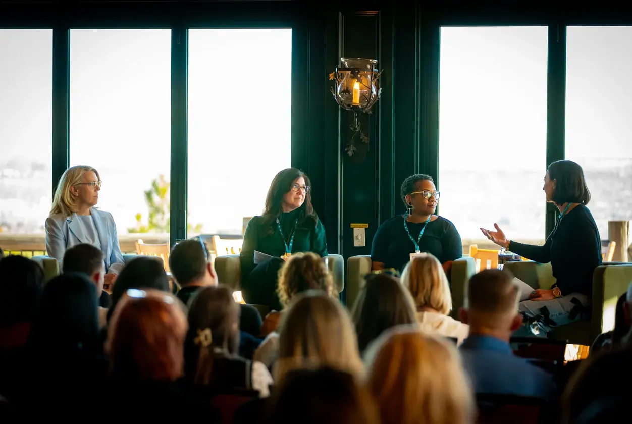 Speakers in a fireside panel discussion