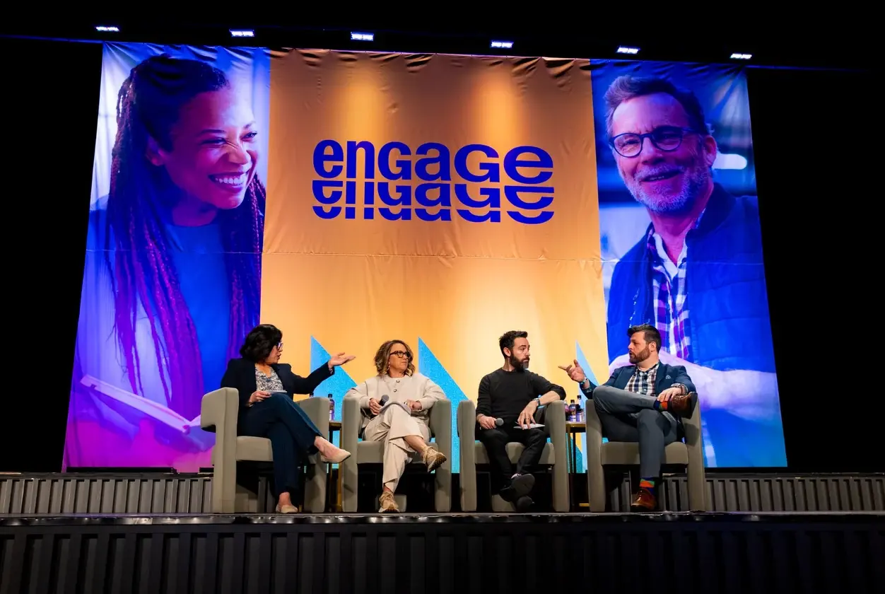 Panelists seated on the main stage