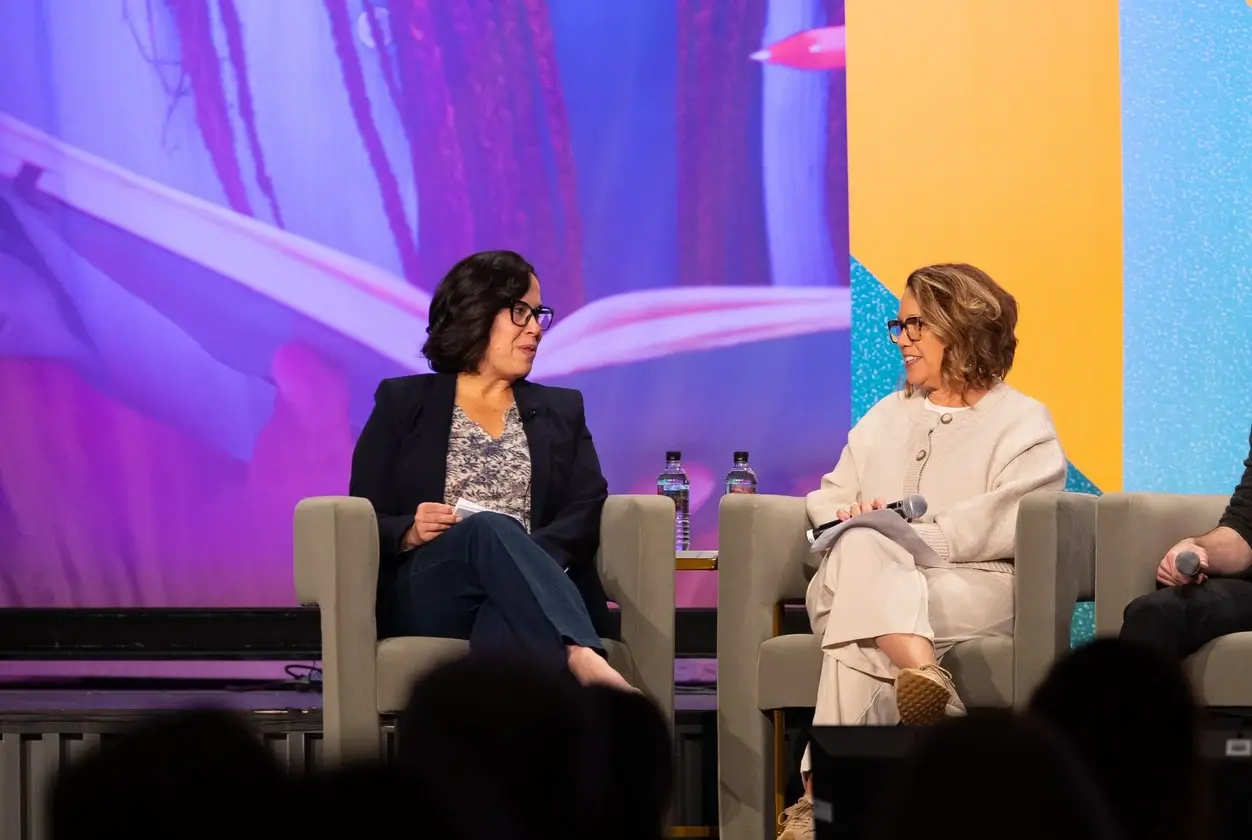 Two speakers in a panel discussion on the ENGAGE stage