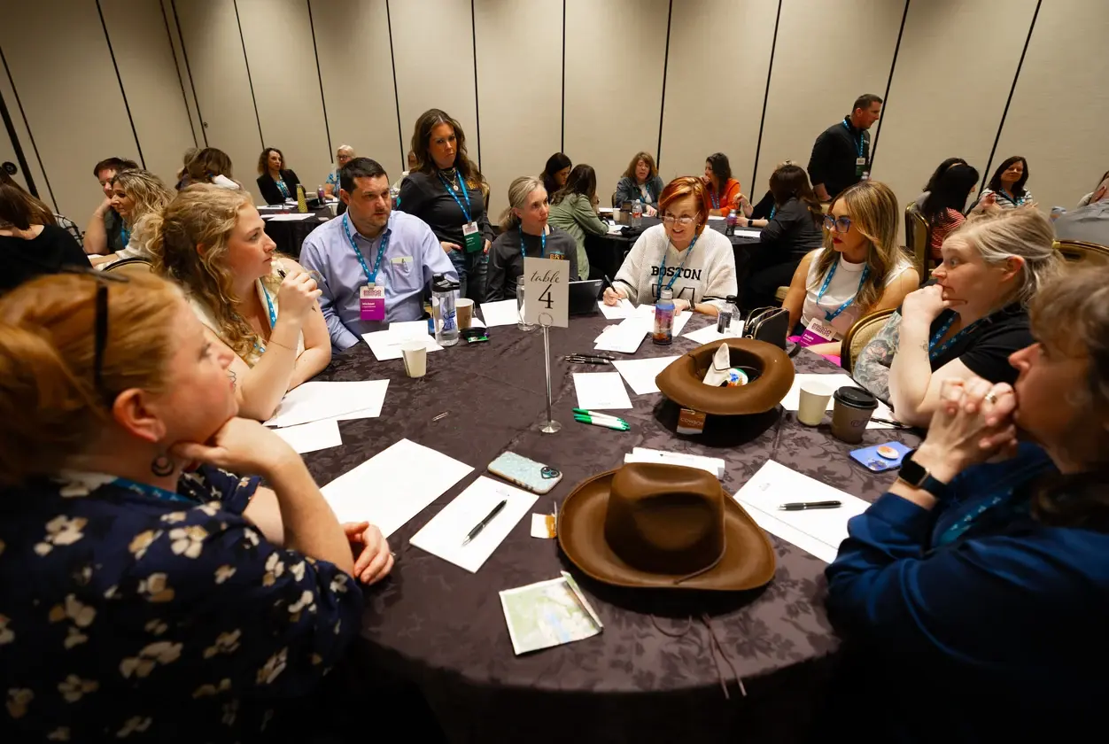 Attendees in a roundtable breakout session