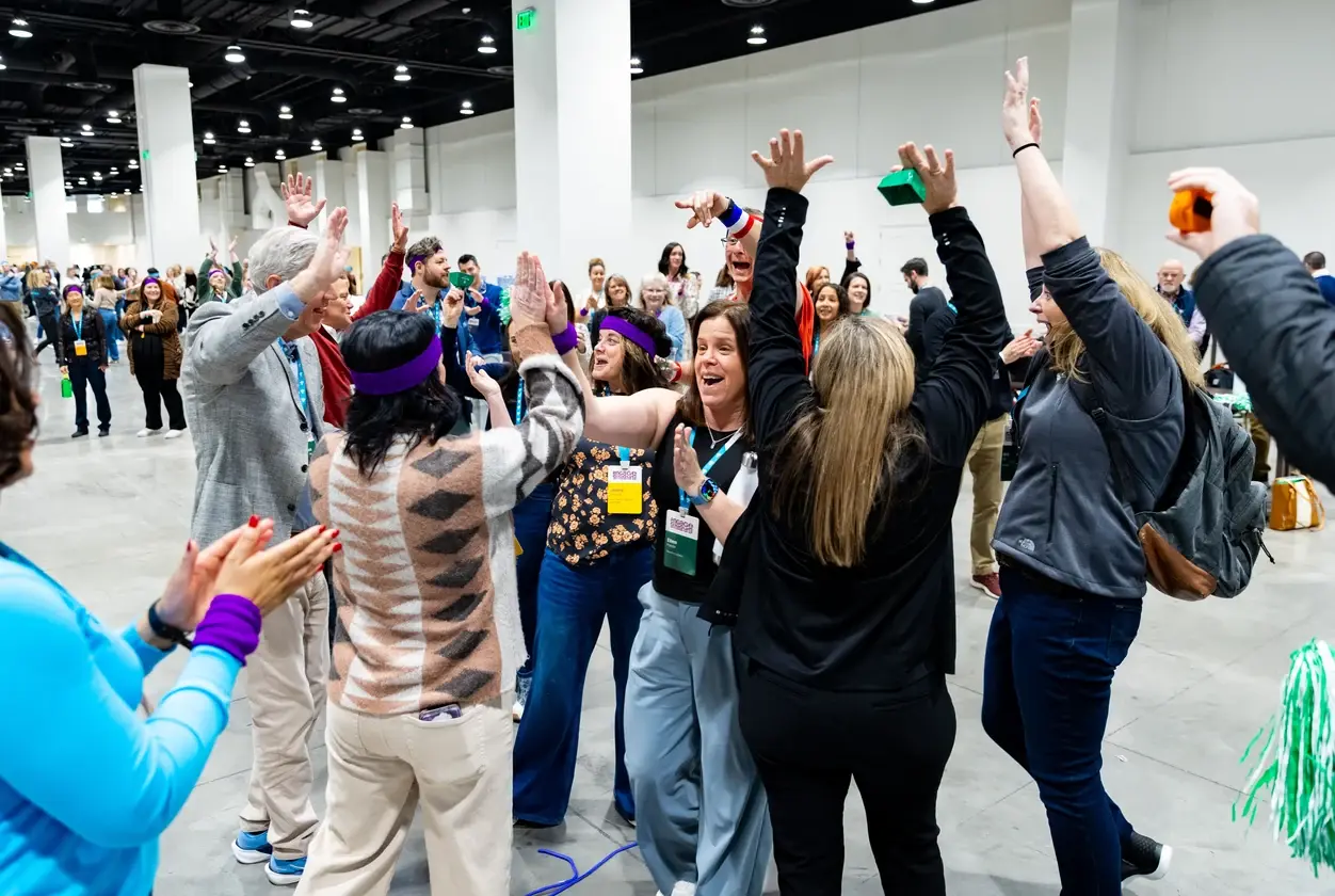 Attendees celebrating during a team-building activity