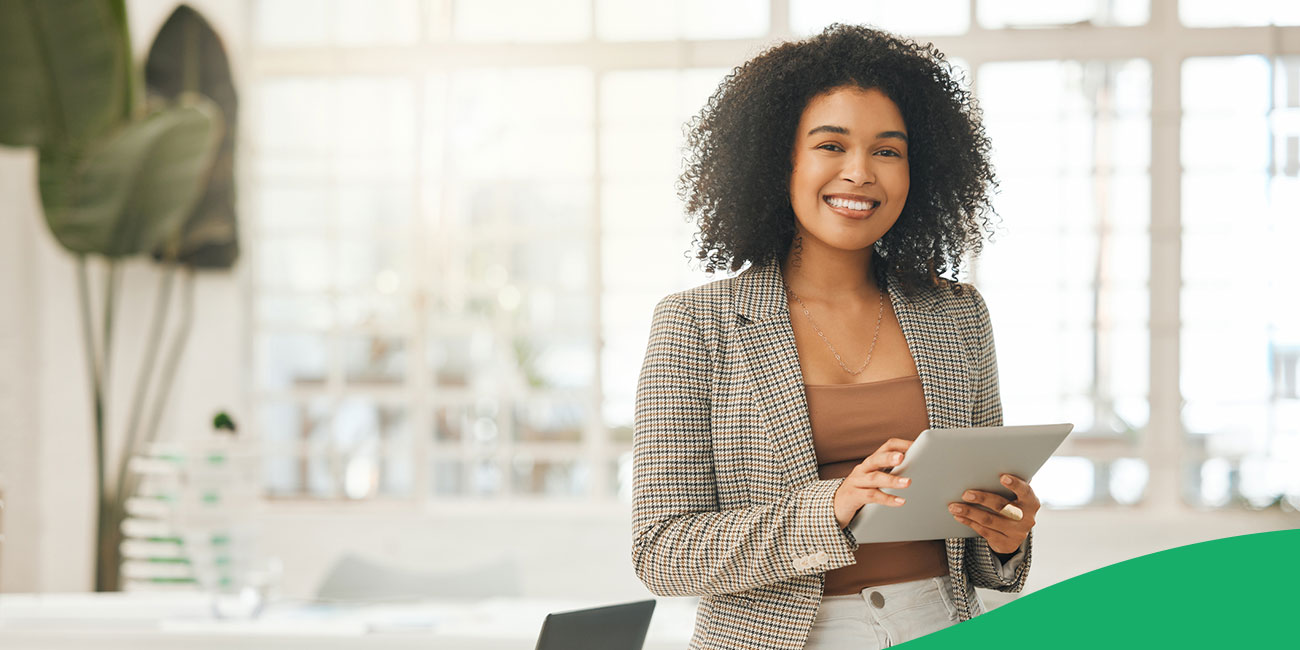 woman smiling holding tablet