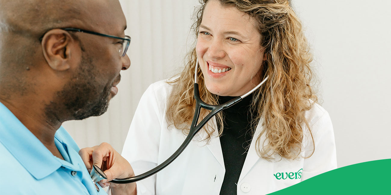 doctor listening to heartbeat of patient