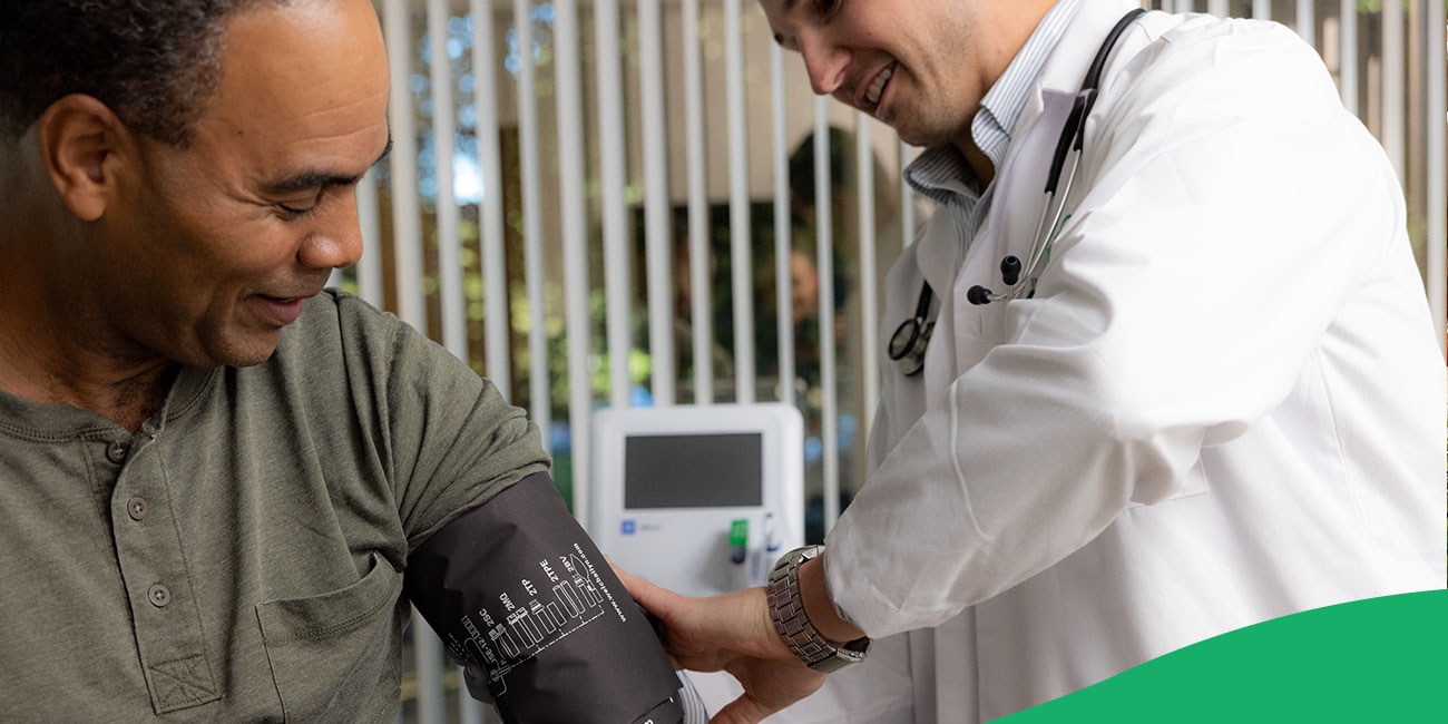 doctor checking patient's blood pressure