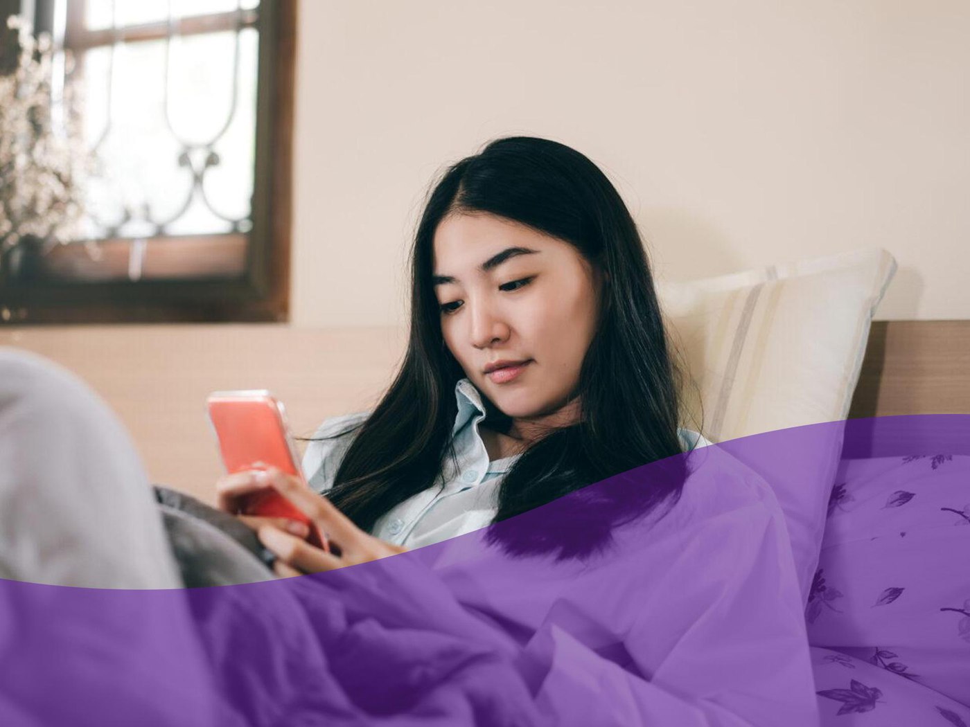 girl sitting down looking at mobile device