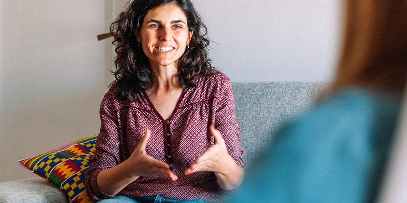 Woman speaking with a mental health counselor