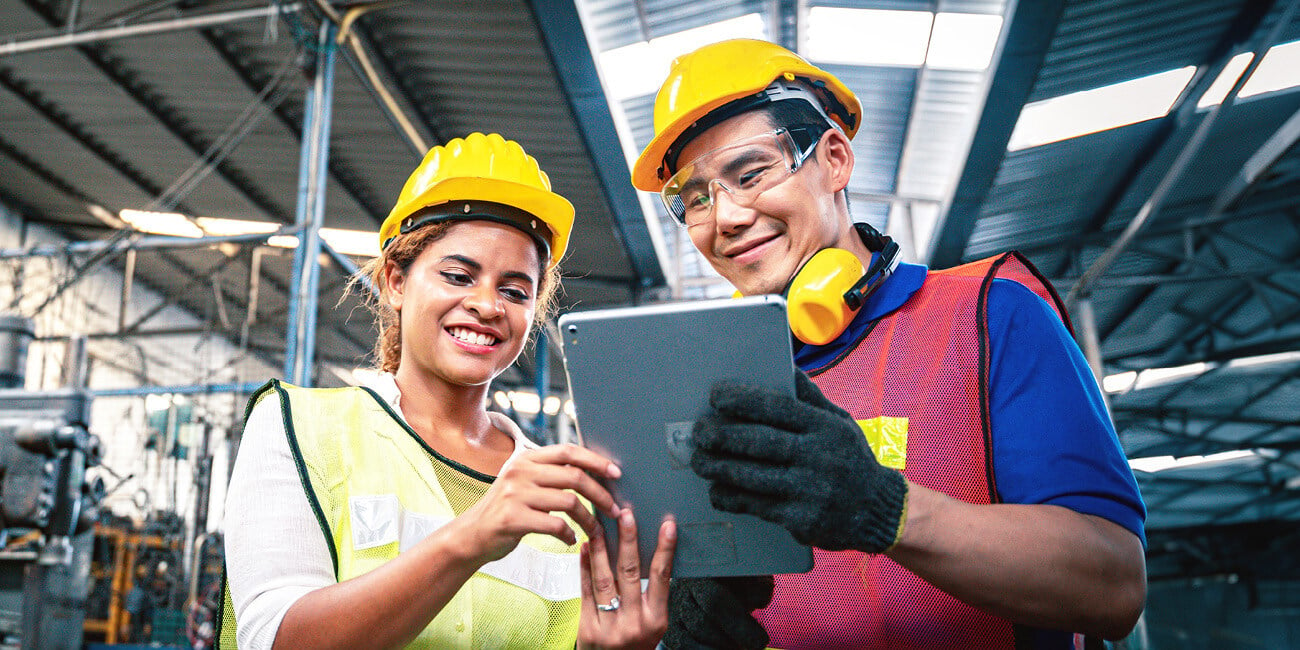 Smiling workers looking at a tablet