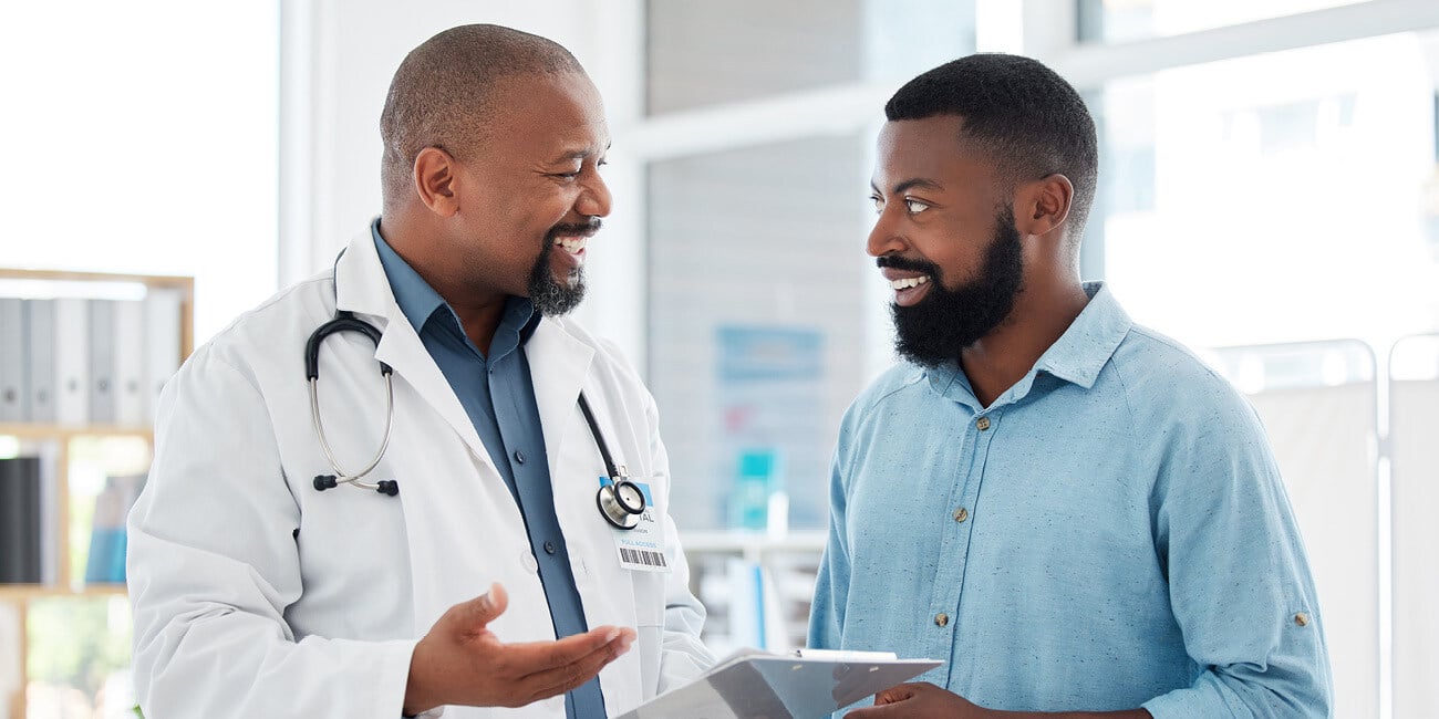 A patient and primary care provider smiling while talking