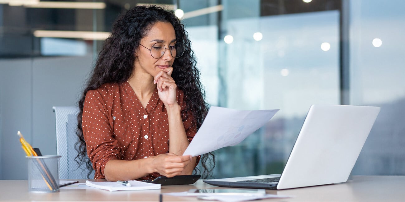 Woman in an office looking at data at her desk