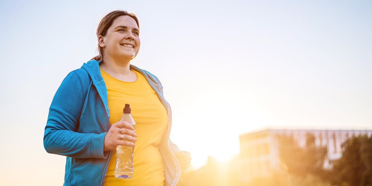 Woman smiling while exercising outside