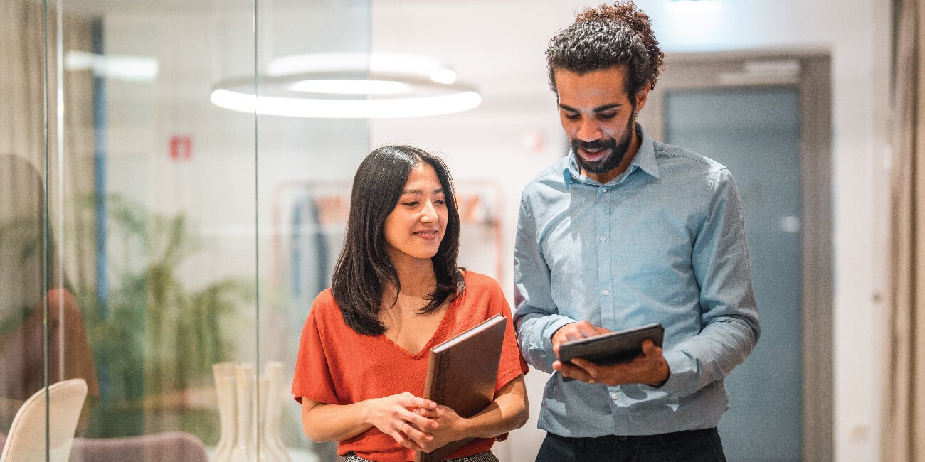 Employees speaking in a hallway