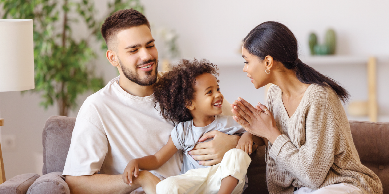 Parents smiling with their child