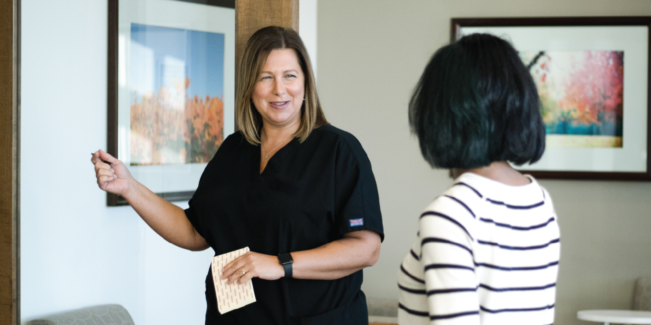 A health center provider welcoming a patient to their appointment