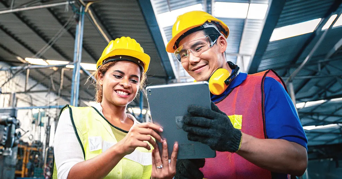 Briggs & Stratton factory workers looking at a tablet device.