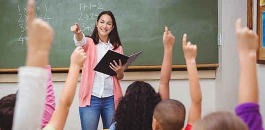 teacher pointing at a student raising their hand