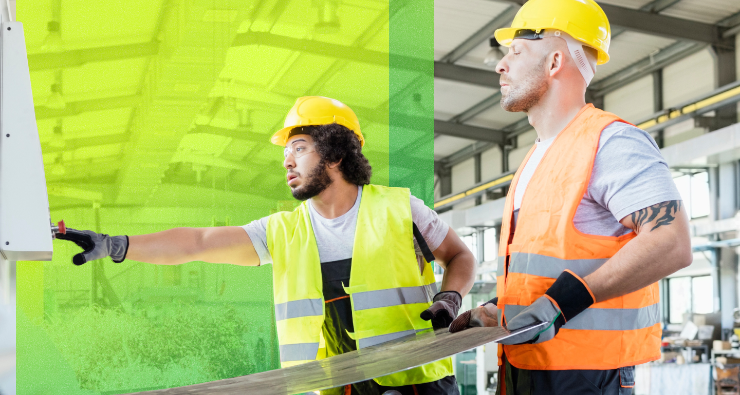 Two ADVICS workers in hard hats and high-visibility vests handle materials inside an industrial facility.