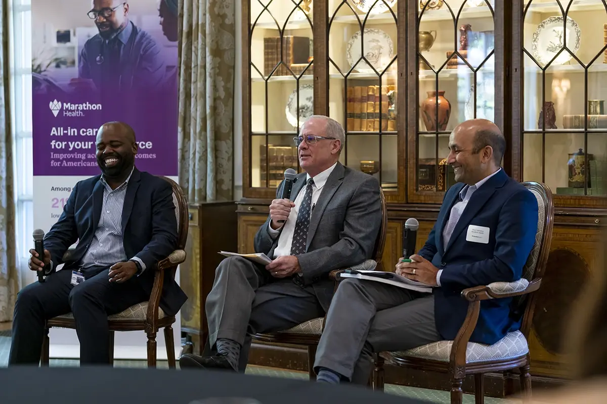 Raynard Washington, Chris Paterson and Nirav Vakharia speaking during an event.