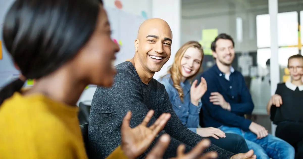 Smiling employees taking part in a corporate wellness program.