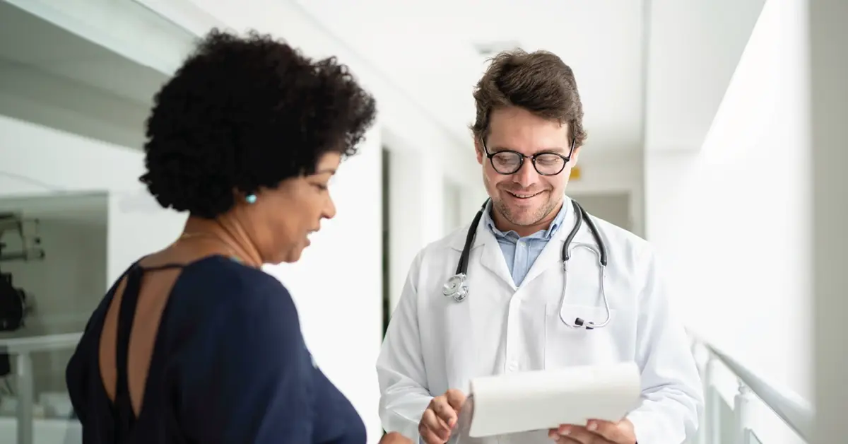 Doctor looking at a patients medical records.