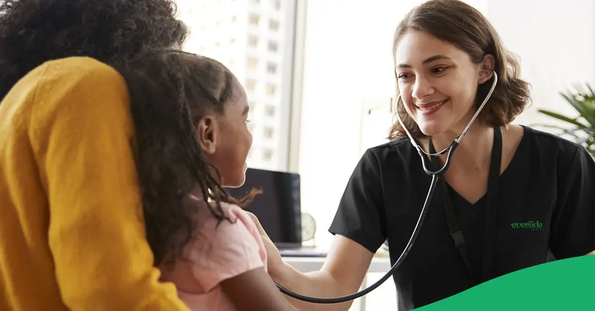Nurse examining a mother and daughter at an employer-sponsored health center.