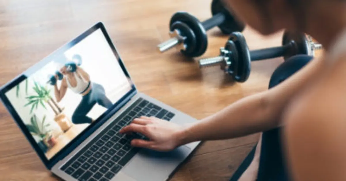 Person watching an exercise tutorial video as part of an health incentive program for employees