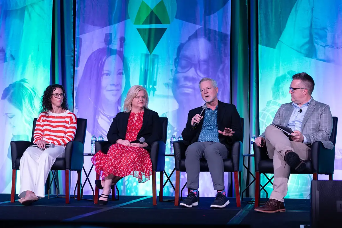 Four speakers giving a talk at Engage 2025.