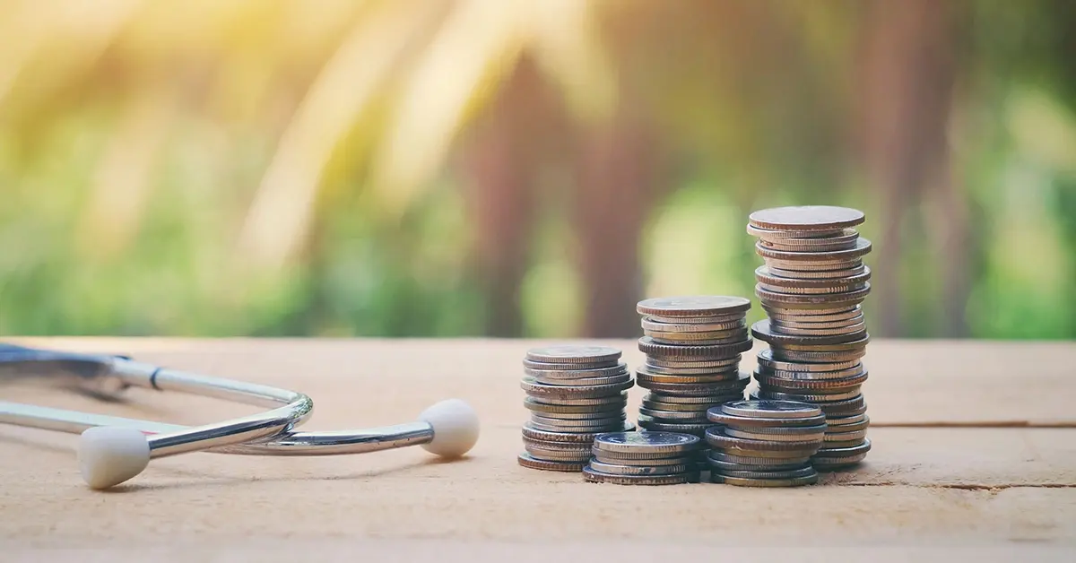 Health center ROI illustrated by a stack of change next to a stethoscope.