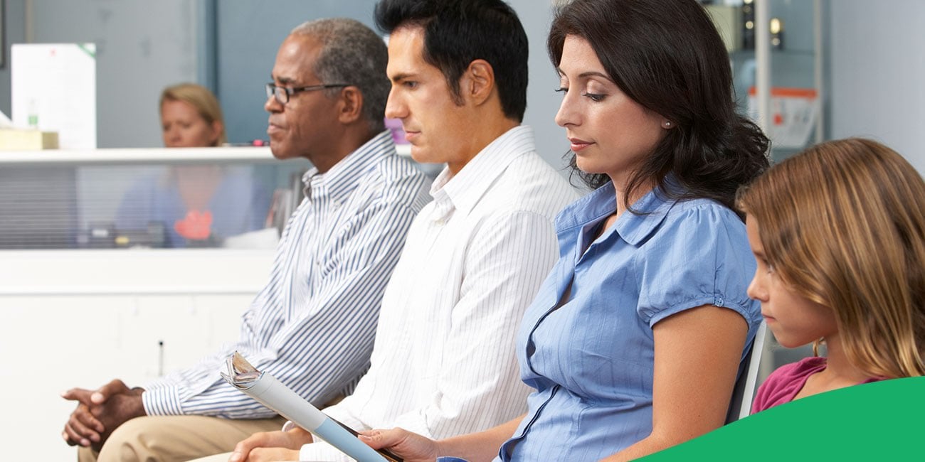 patients sitting close in a full waiting room